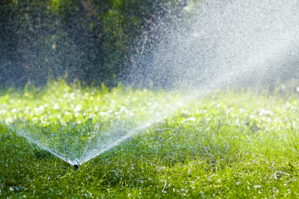 Lawn water sprinkler watering grass in someones lawn